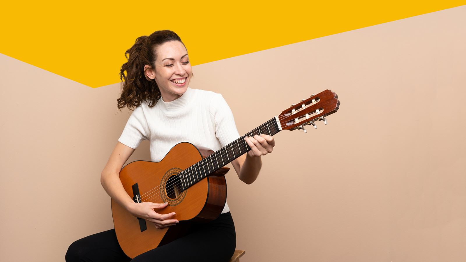 Woman with guitar (with a yellow design element above)